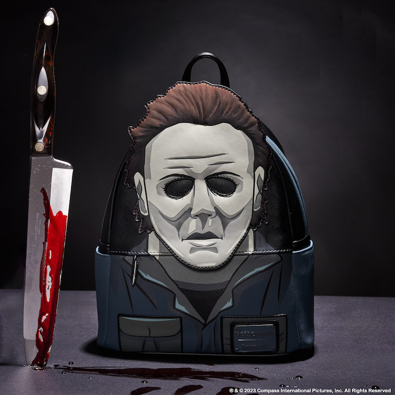Image of our Michael Myers Cosplay Mini Backpack next to a large kitchen knife with fake blood on it 